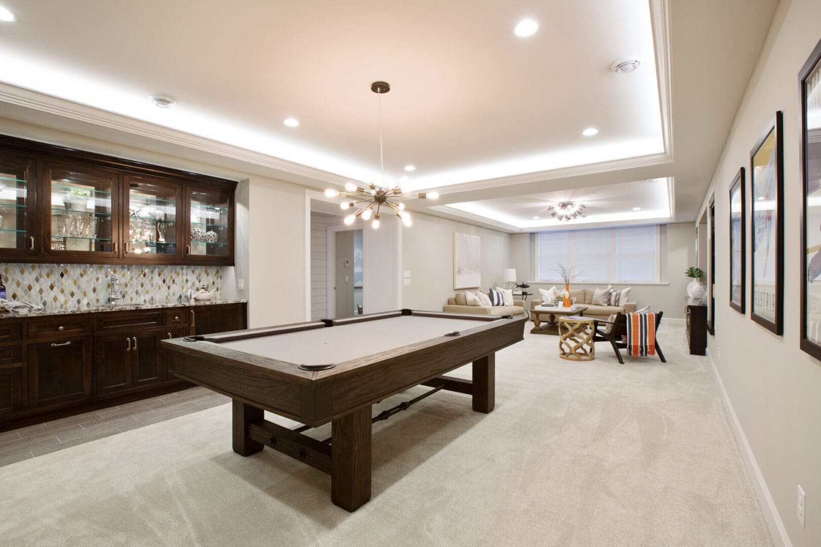 Billiards table with kitchenette nearby for everything you need in the basement